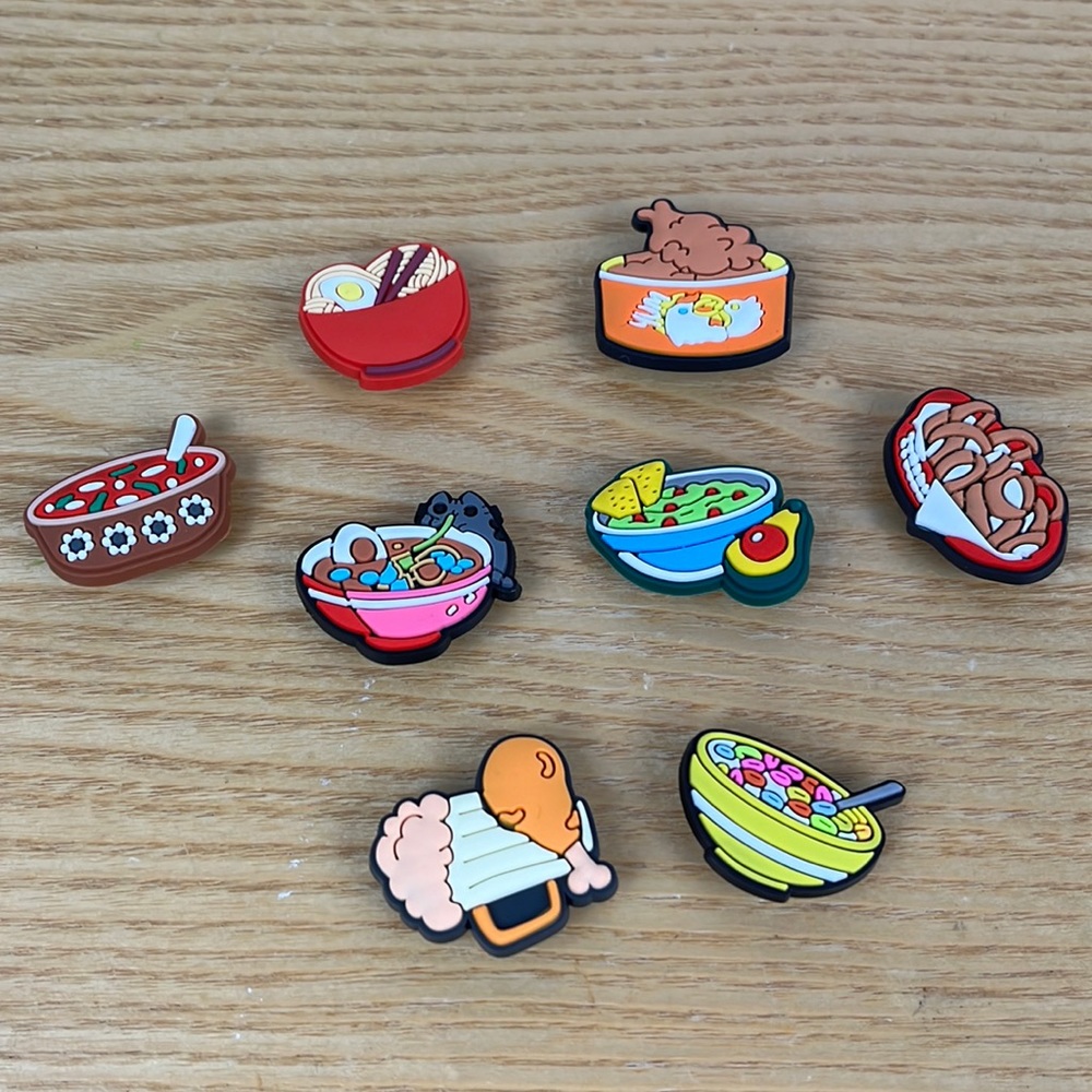 8 different bowls of food, croc charms